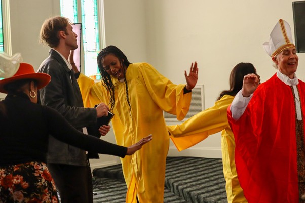 Behind the scenes cast in costume on stage