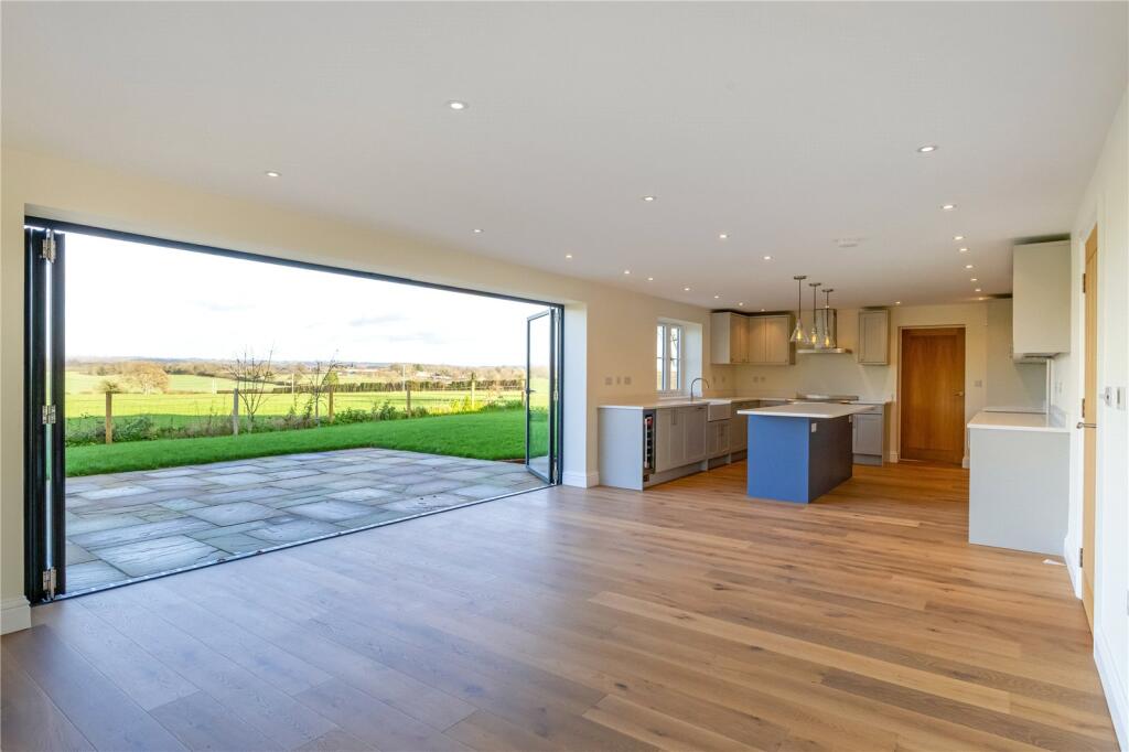 Empty new build open-plan kitchen and breakfast room before virtual staging — unfurnished with fitted kitchen units visible