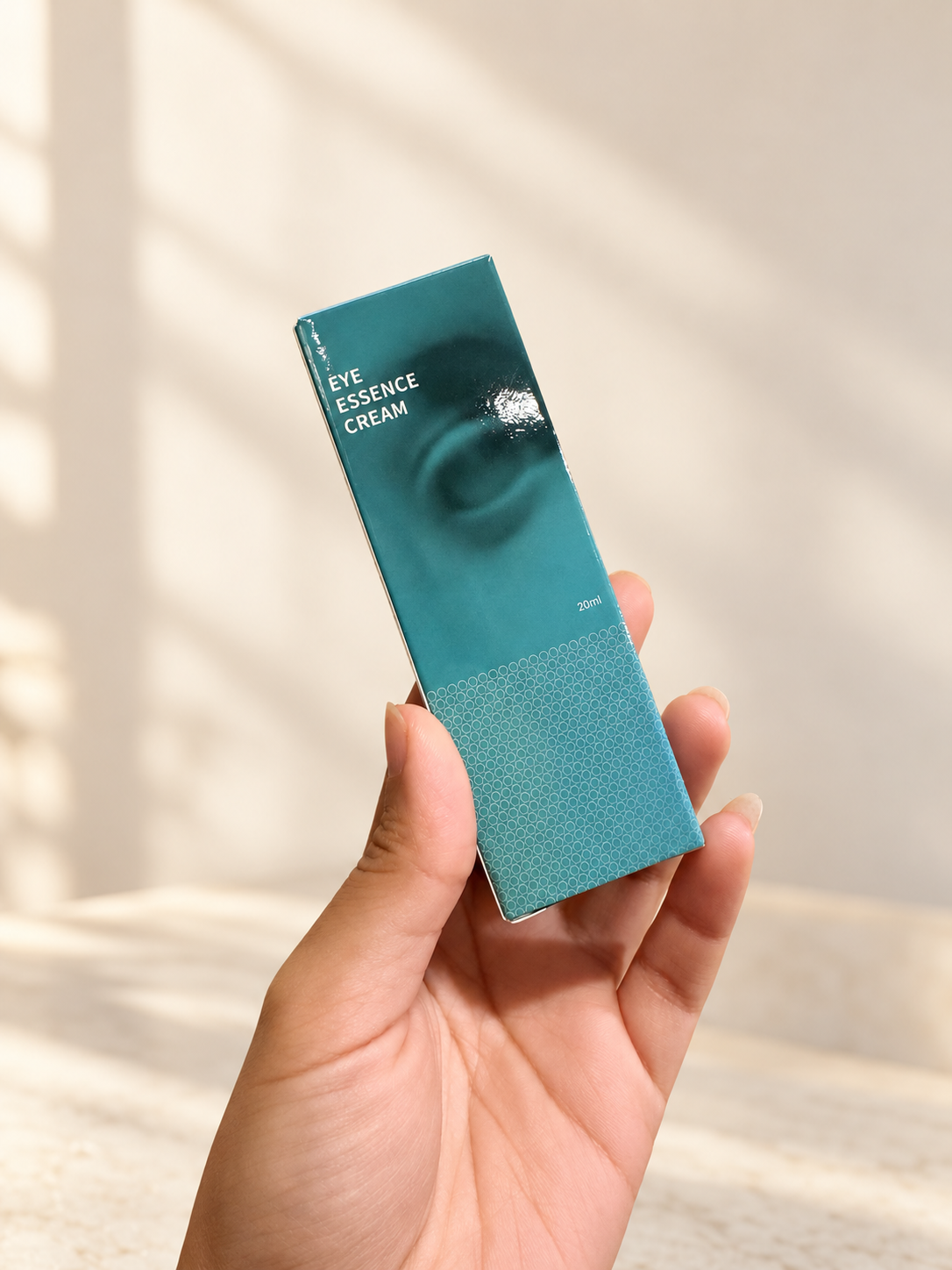 Eye Essence Cream box front held by hand