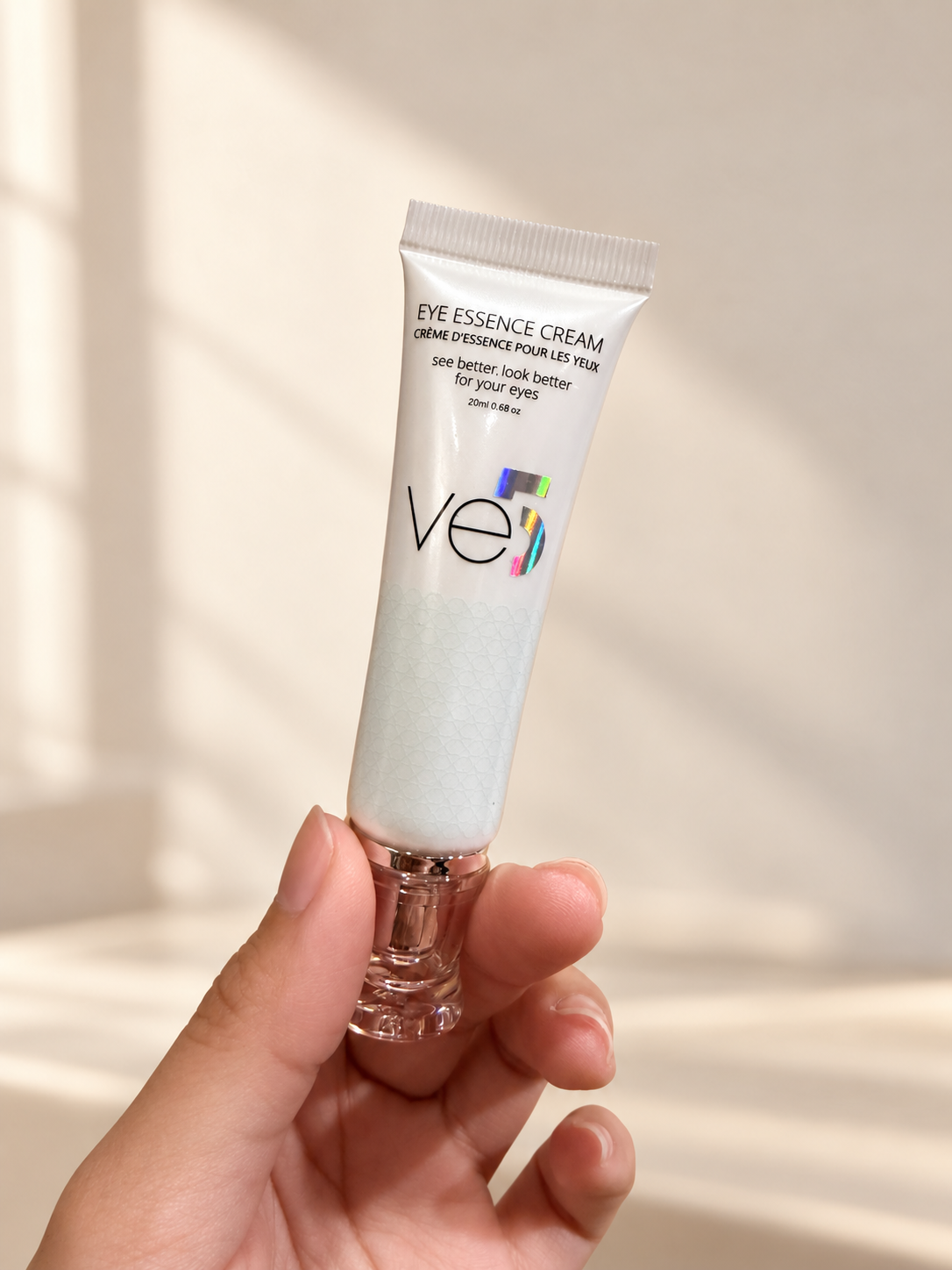 Eye Essence Cream tube held by hand
