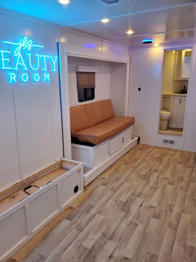 Salon trailer interior with beauty room neon sign