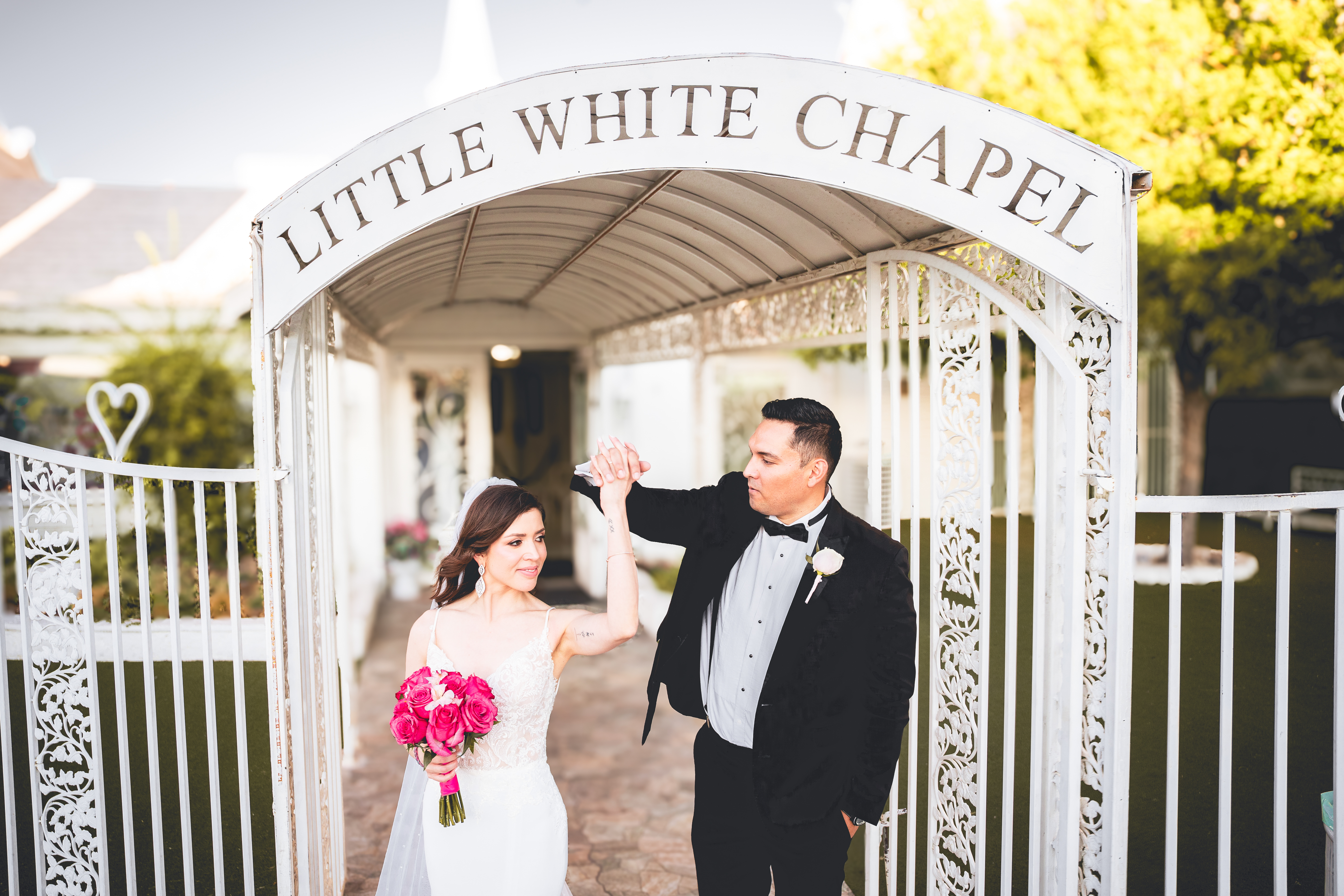 Bride and groom under the Little White Chapel arch