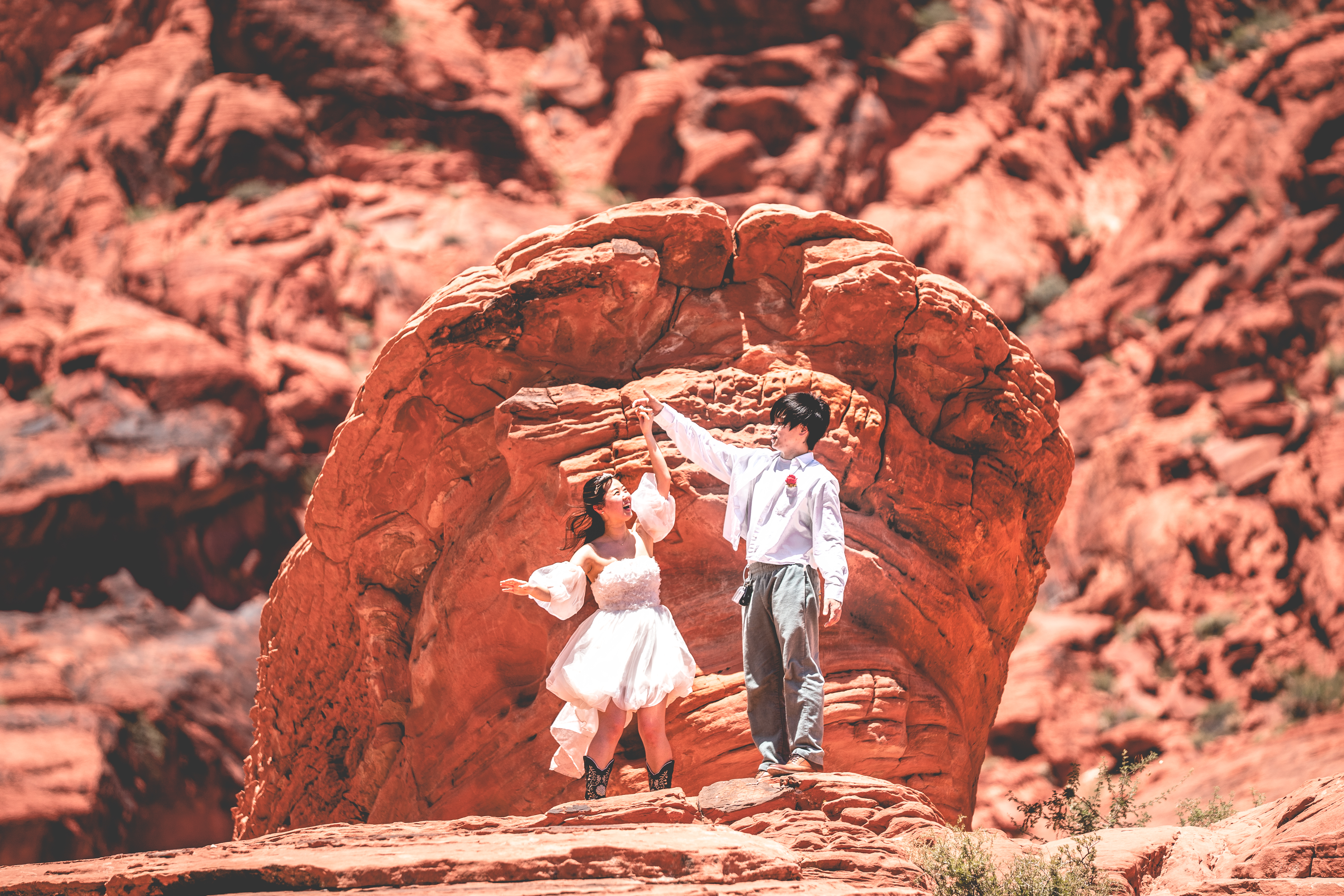 Couple posing on a desert rock formation