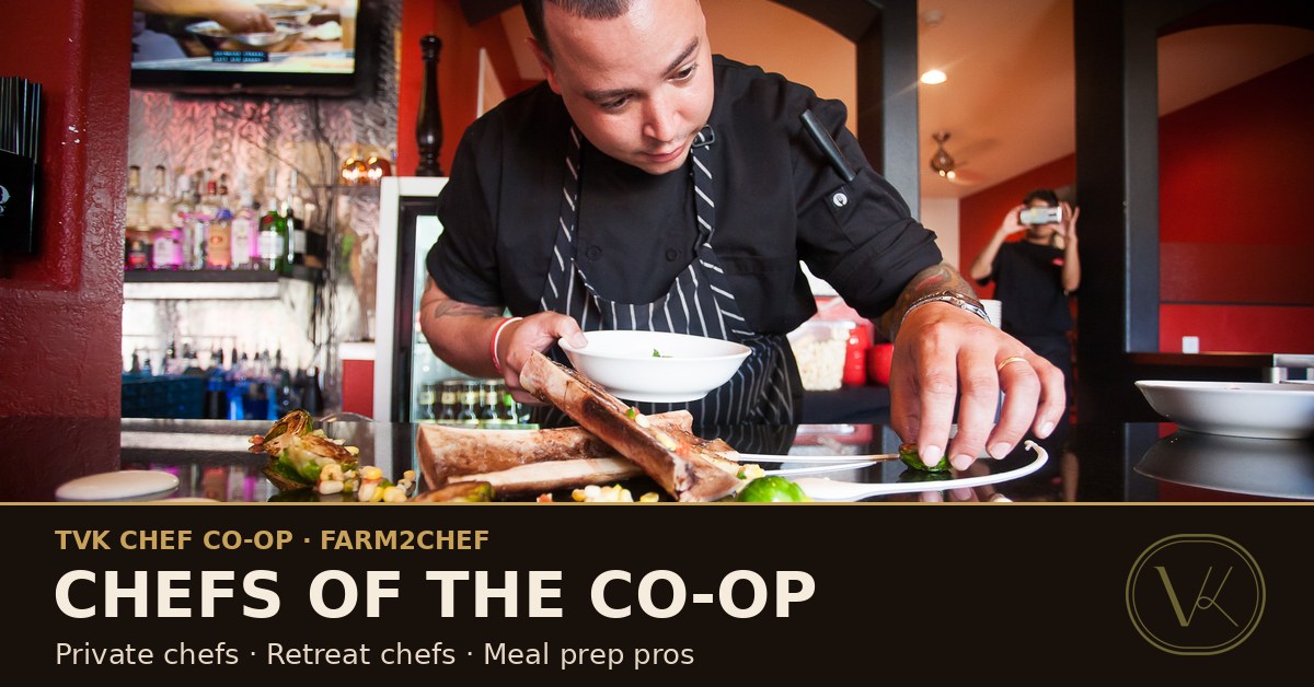 A professional chef plating dishes at a restaurant pass