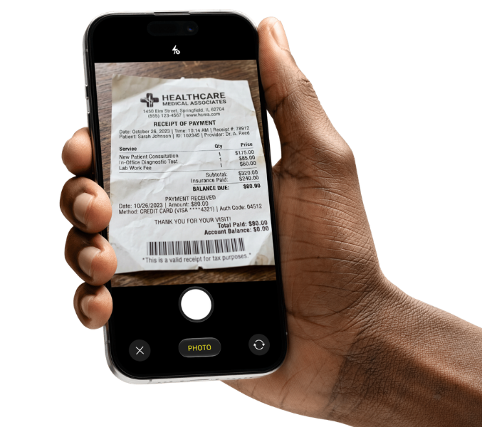 A hand holding a phone capturing a medical payment receipt with the XpenseDash camera.