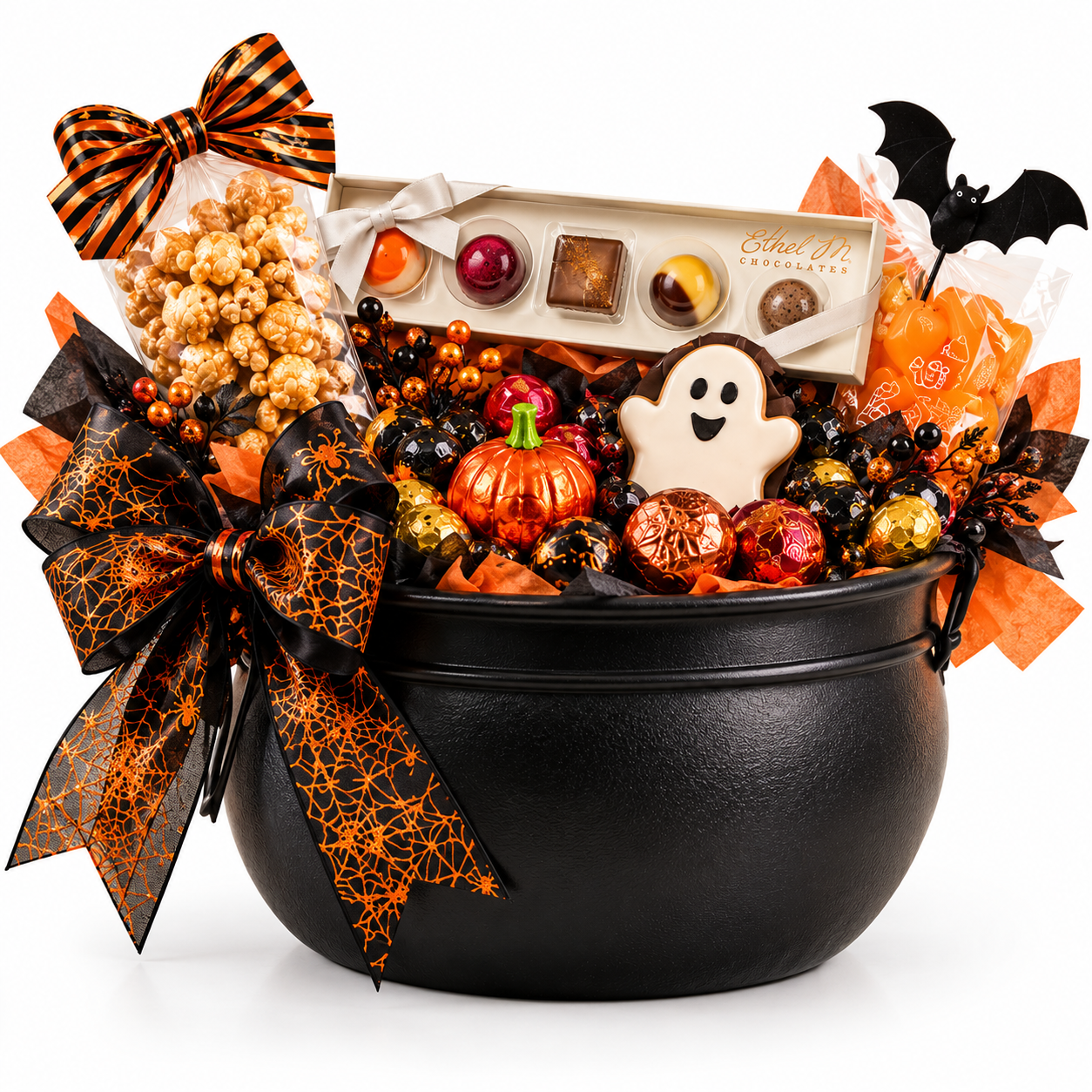 Matte black Halloween cauldron filled with an Ethel M chocolate box, caramel popcorn, a ghost cookie and orange spiderweb bow.