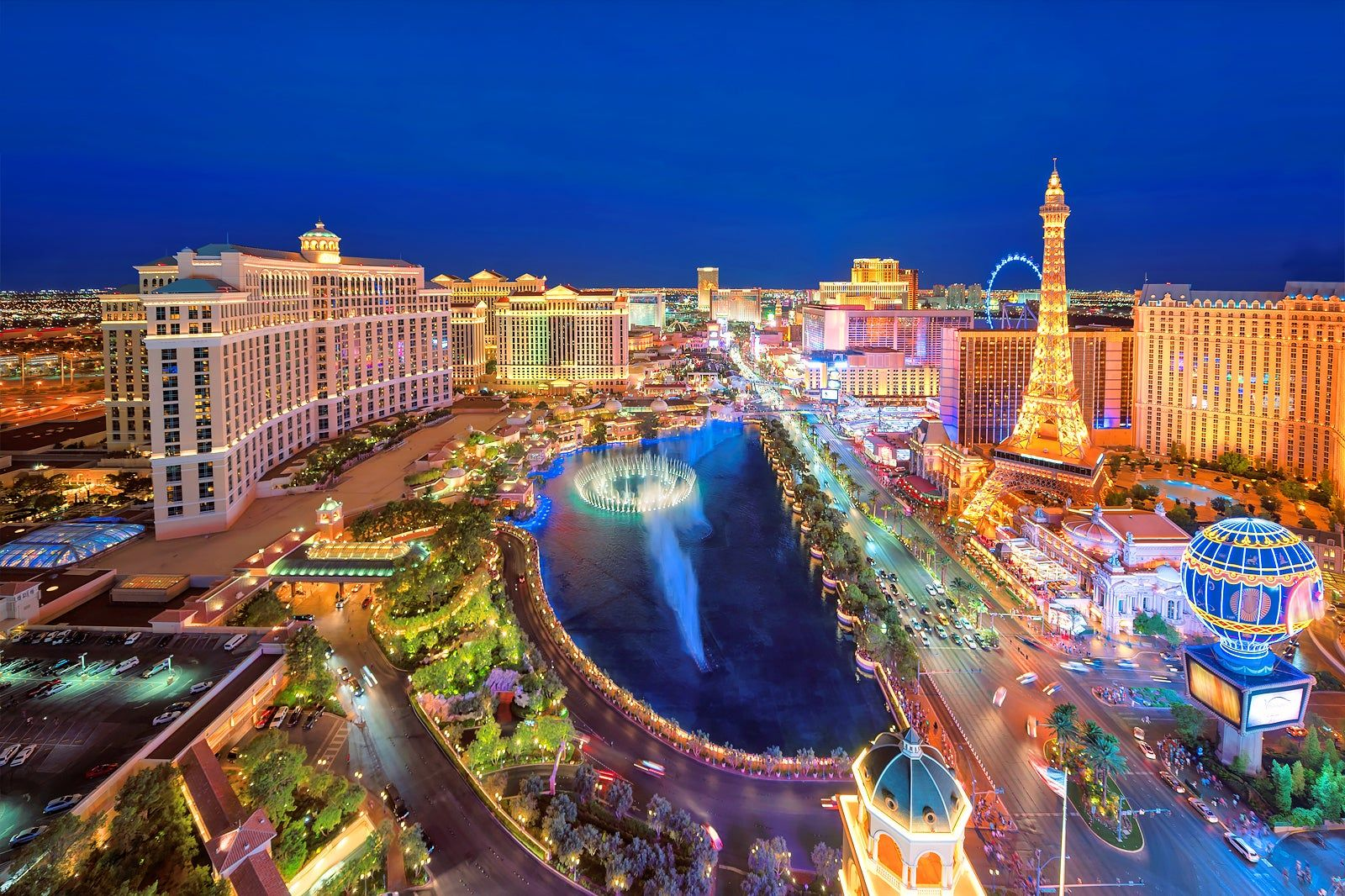 Aerial night view of the Las Vegas Strip with the Bellagio fountains and Paris Las Vegas Eiffel Tower — Las Vegas hotel flower delivery by Bud Weismiller