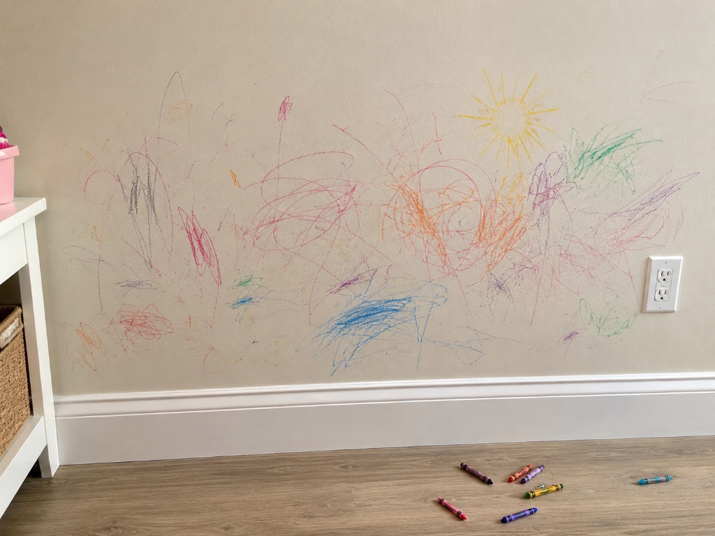 Wall covered with colorful crayon markings illustrating tenant damage