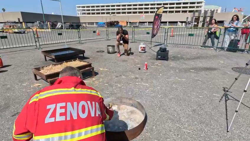 Zenova team member conducting fire test in branded jacket