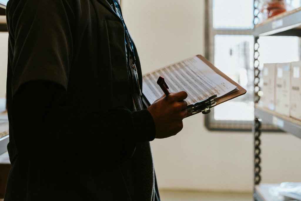 Vendor reviewing compliance documents in warehouse