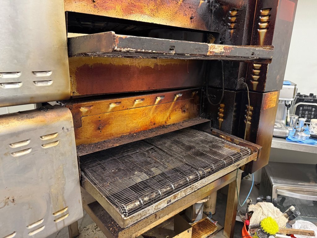 Interior heavily carbonized — years of baked-on buildup