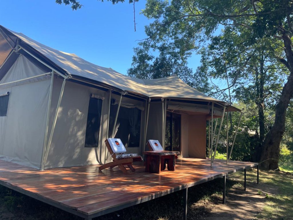 Open safari vehicle and guide on a game drive in Kafue National Park