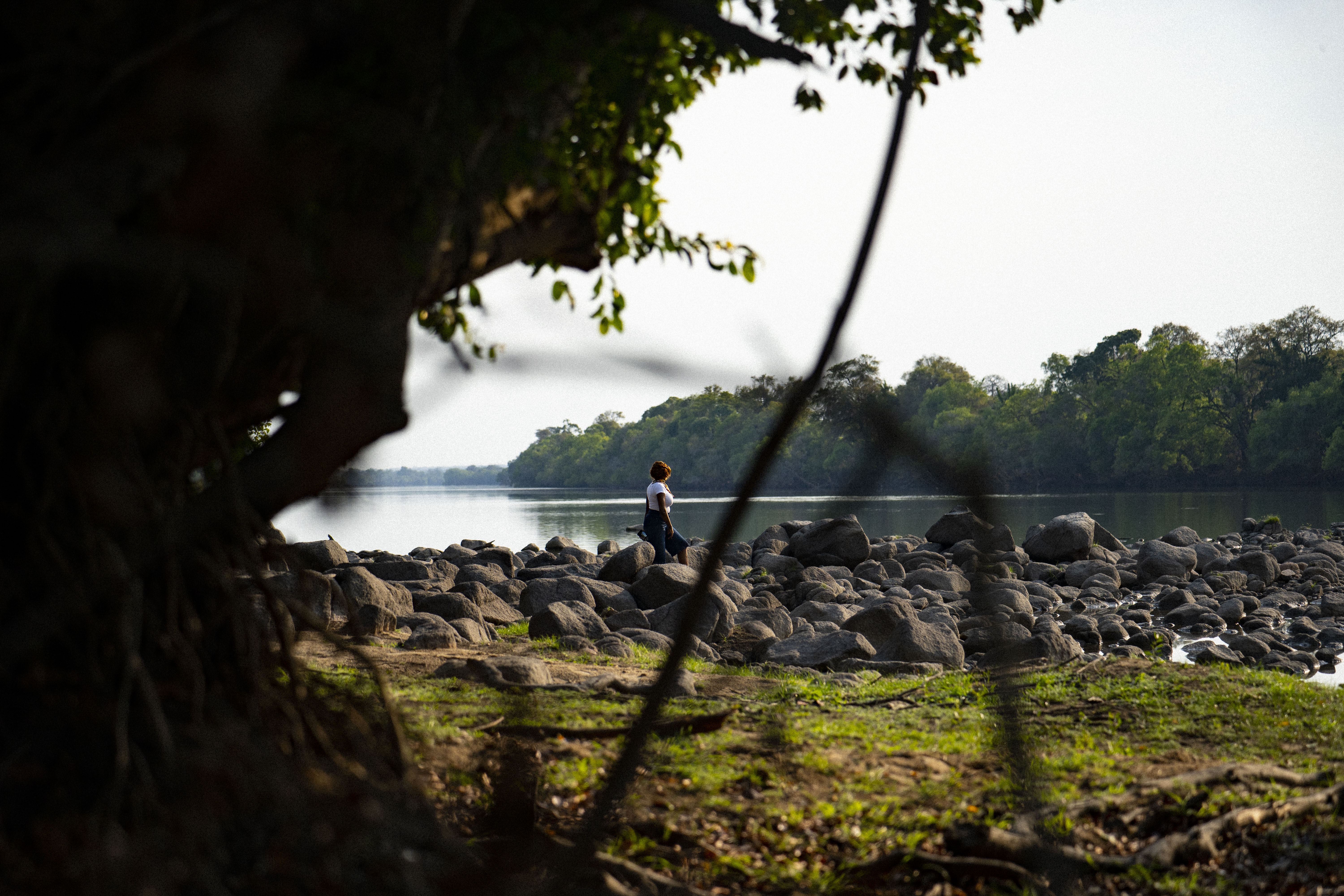 Guest walking along the rocky Kafue riverbank