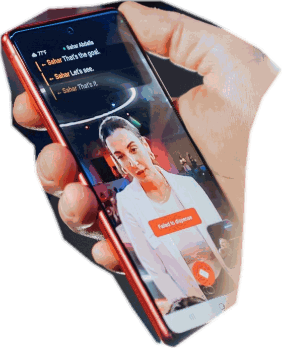 A hand holding a phone showing a live video call