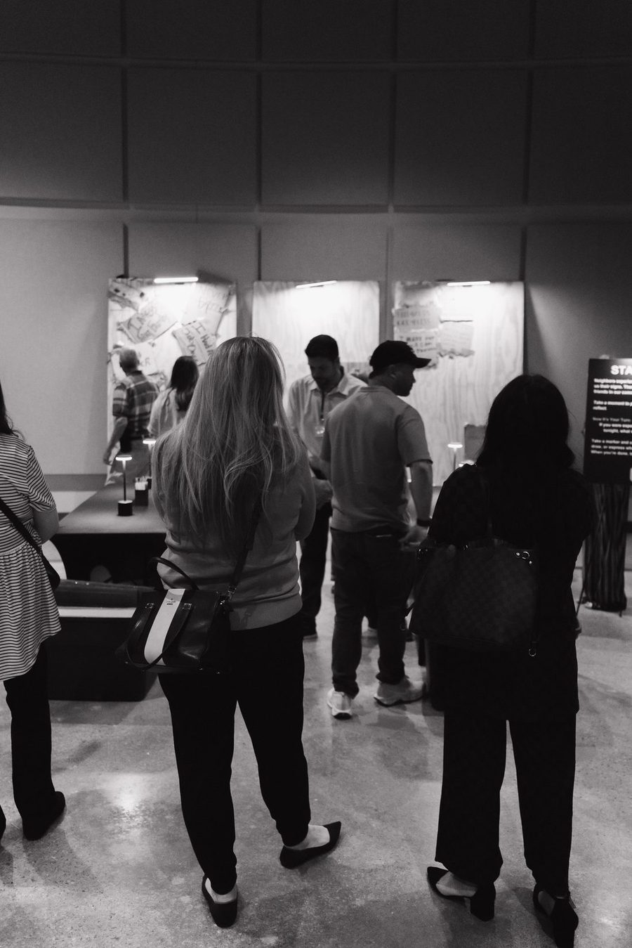 Visitors standing in front of lit sign panels