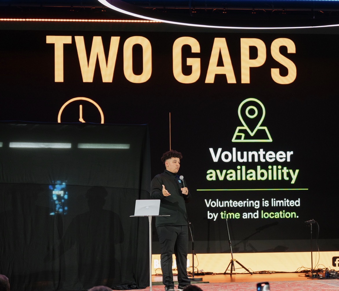 A BeHeard team member on stage presenting the Two Gaps: after-hours access and volunteer availability