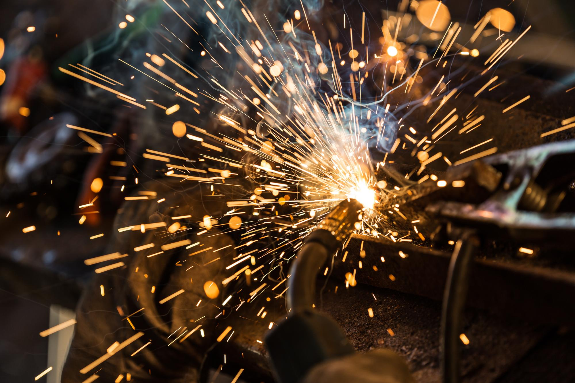 Welding sparks flying during precision metalwork
