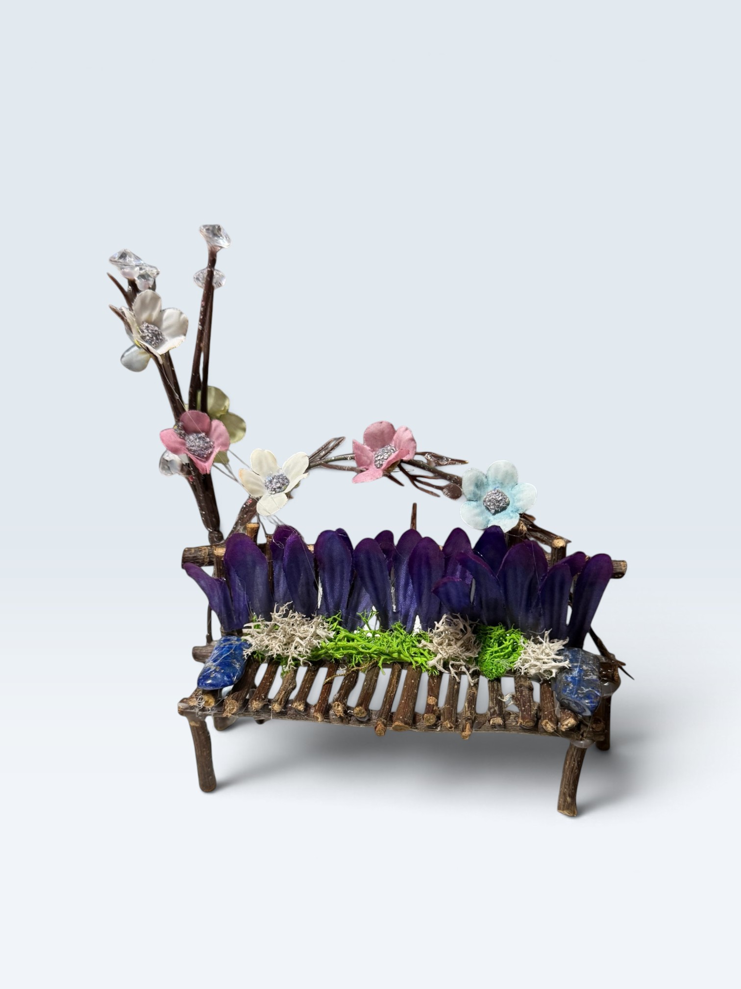 Enchanted Petal Perch - handcrafted miniature twig bench with purple petals, moss, pastel blossoms, and lapis lazuli crystal armrests