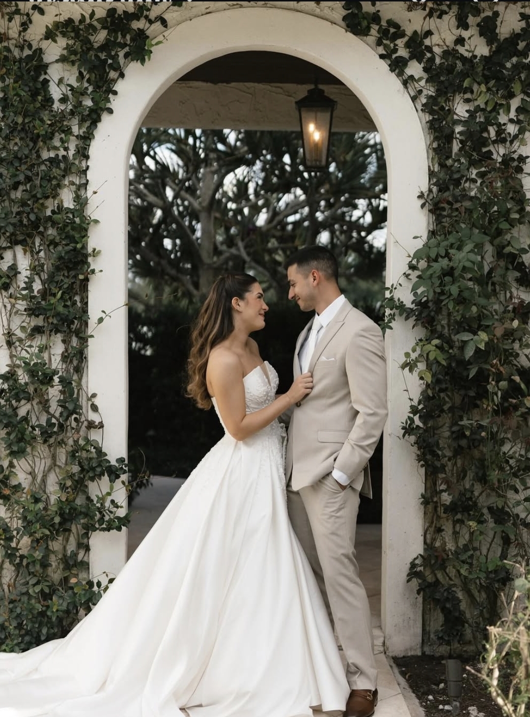 Bride beneath the ceremony archway
