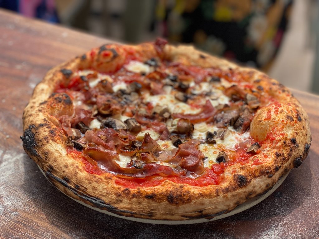 Prosciutto and mushroom pizza fresh from the oven