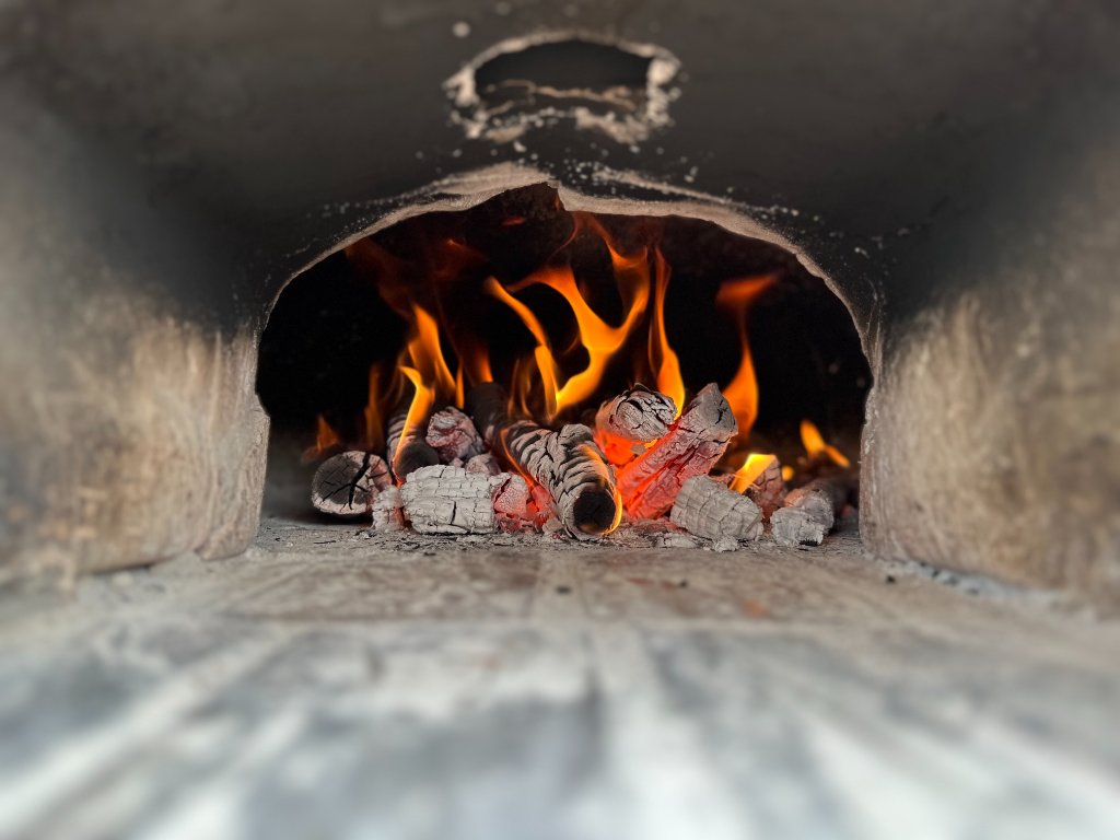Glowing embers inside the woodfire oven