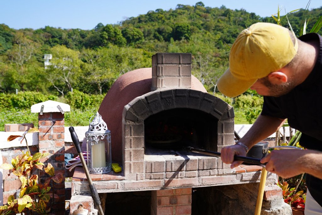 Guests helping launch pizza into the oven