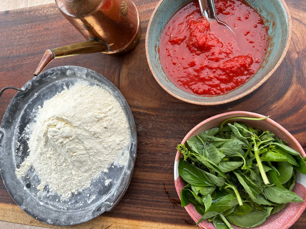 Flour, tomato sauce and fresh basil — pizza ingredients