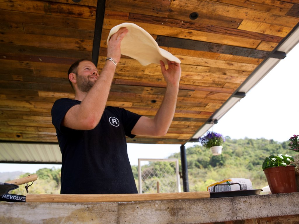 Jamie tossing pizza dough
