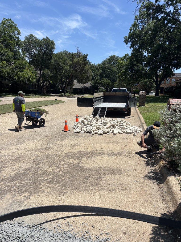 Visionary Outdoor Solutions crew installing drainage and hardscape