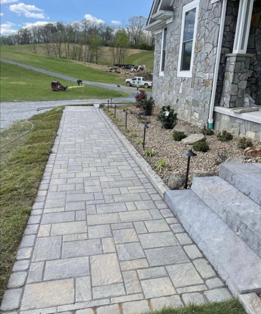 Paver walkway leading to stone-clad house