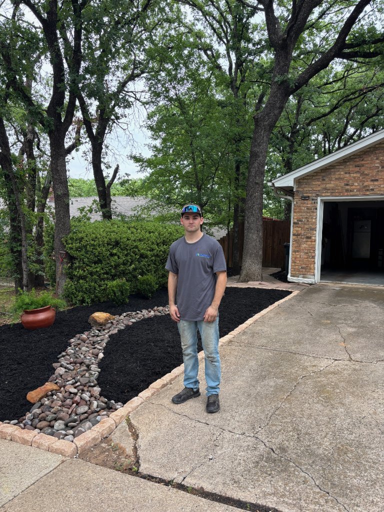 Visionary Outdoor Solutions owner standing in front of a completed landscaping project