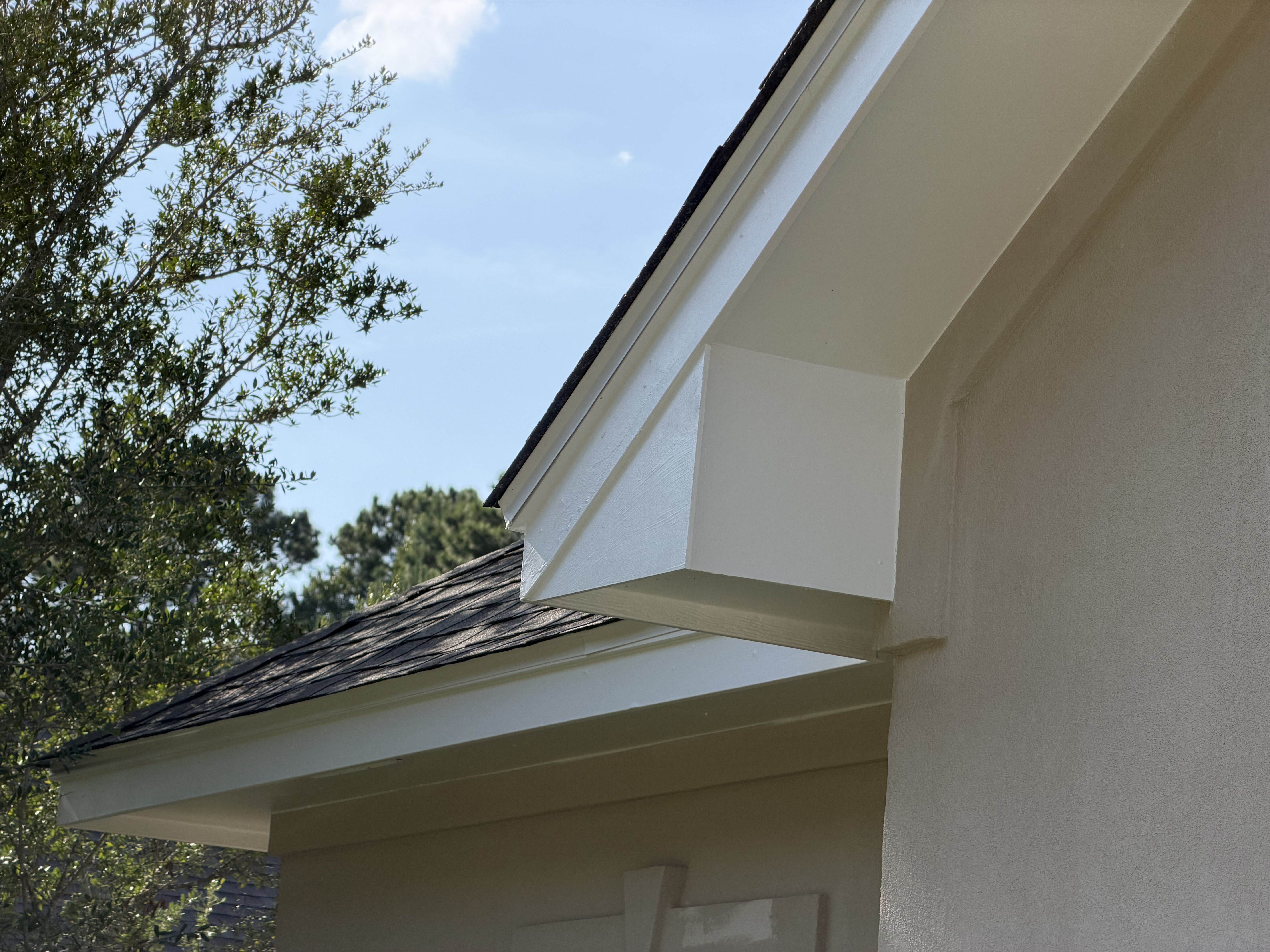Freshly painted fascia and soffit return at roof corner