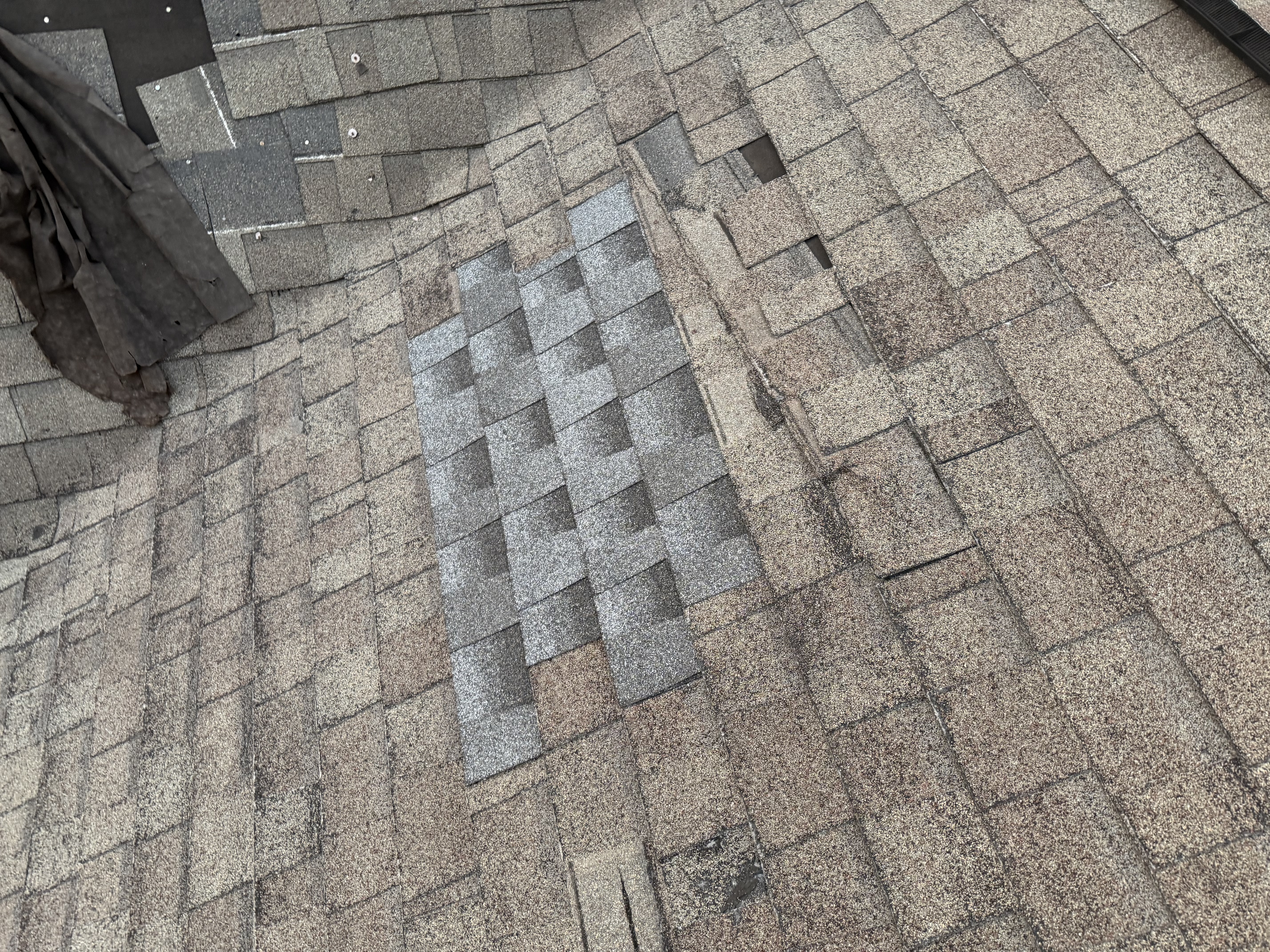 Mismatched patch shingles showing improper shingle repair