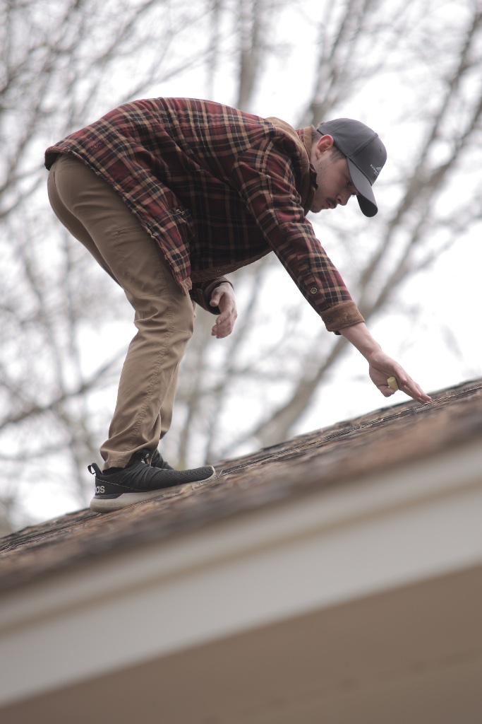 Close-up of roof shingle condition during an inspection