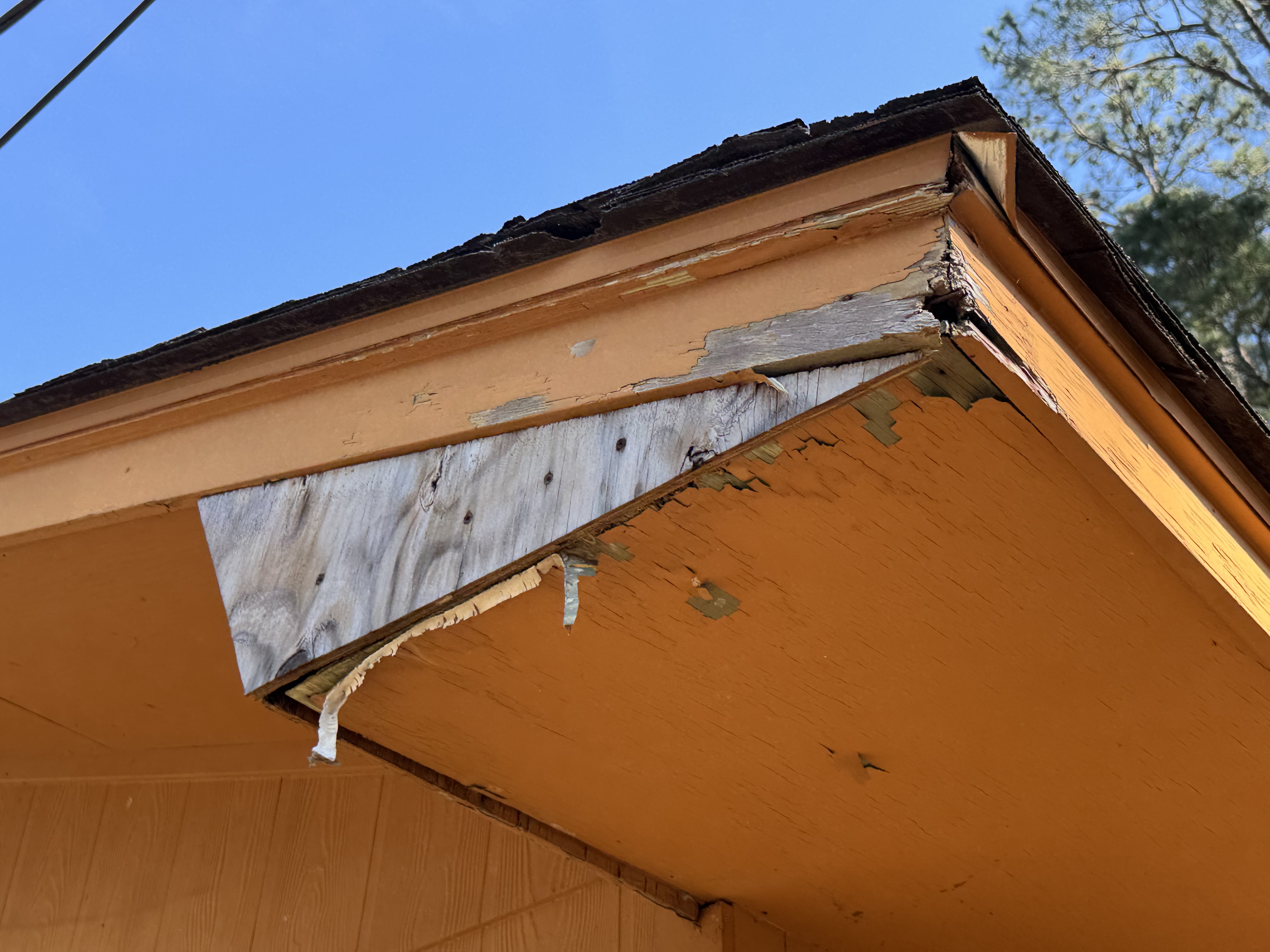Loose corner trim with weathered exposed wood