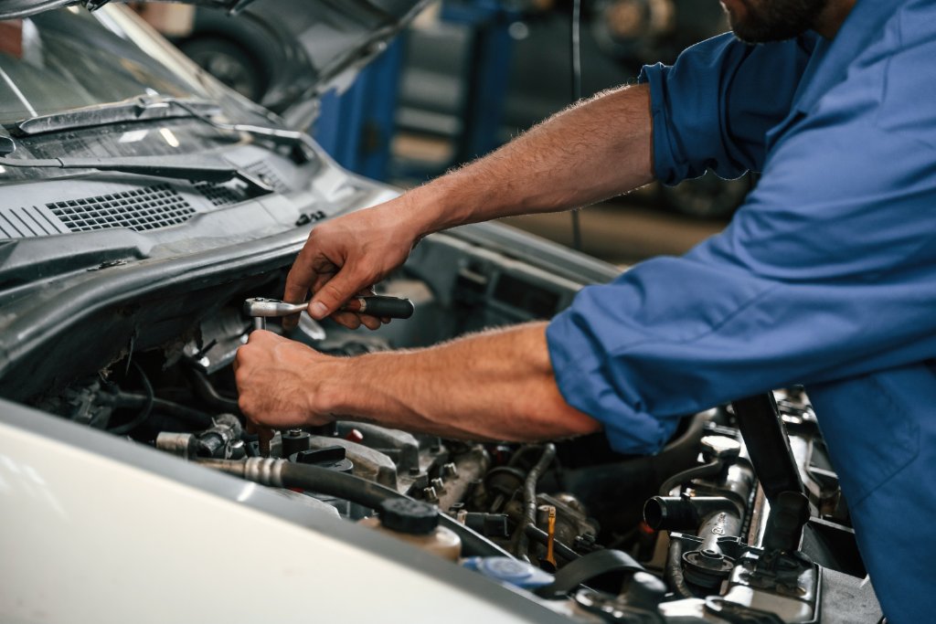 Mechanic repairing engine
