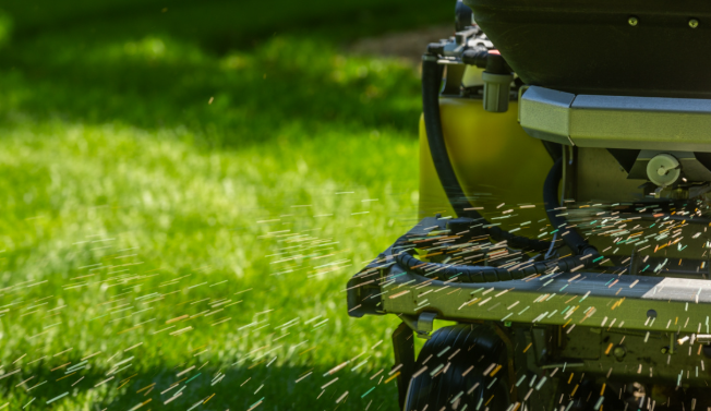 Granular fertilizer being applied to a lawn