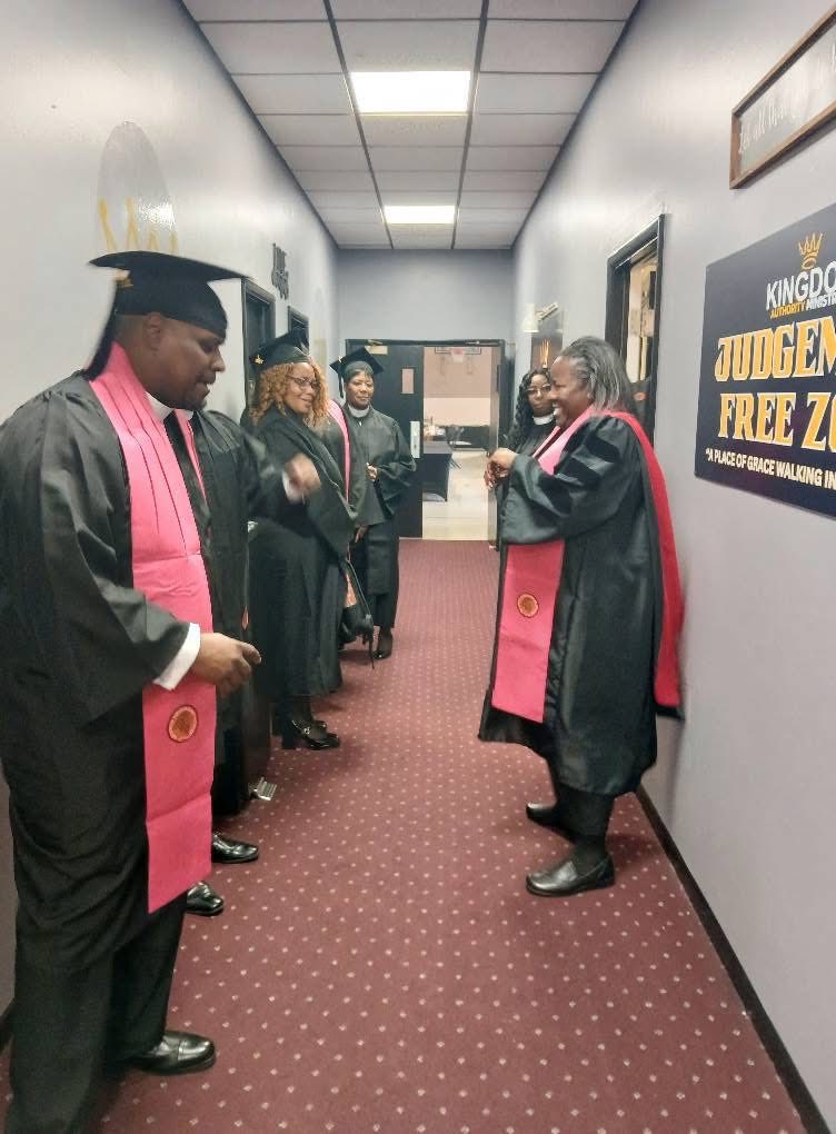 Apostolos graduates preparing in the hallway
