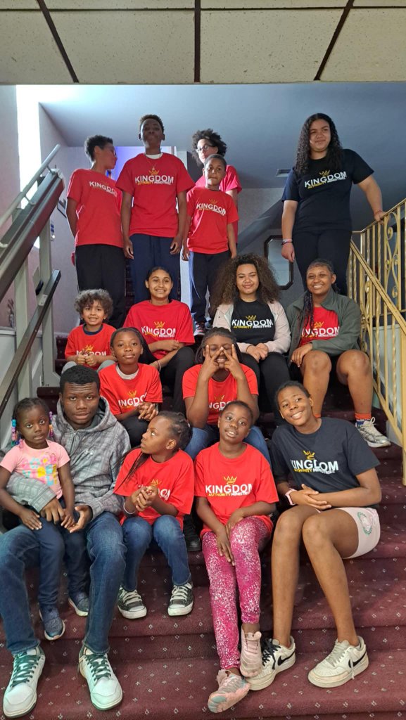 Diverse youth group engaged in animated Bible study in a warm, intimate setting