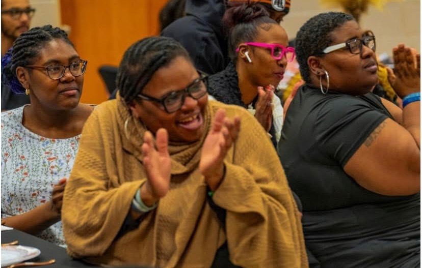 Diverse women in a prayer circle, hands joined in peaceful worship