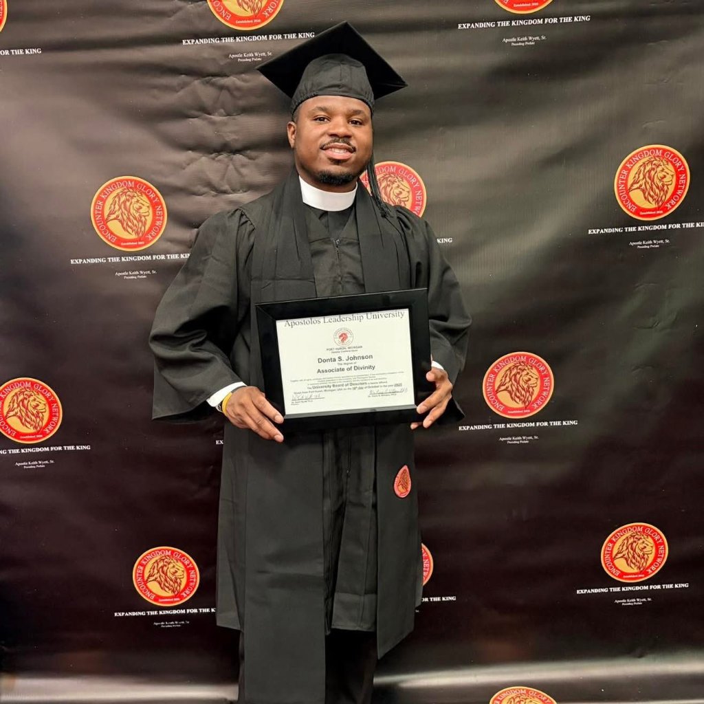Graduate holding Apostolos Leadership University diploma