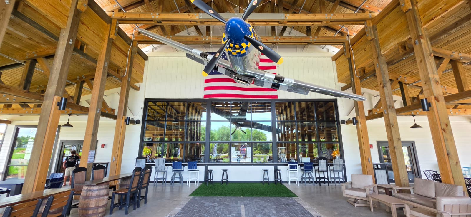 Full-scale aircraft suspended above the central bar inside Props Craft Brewery