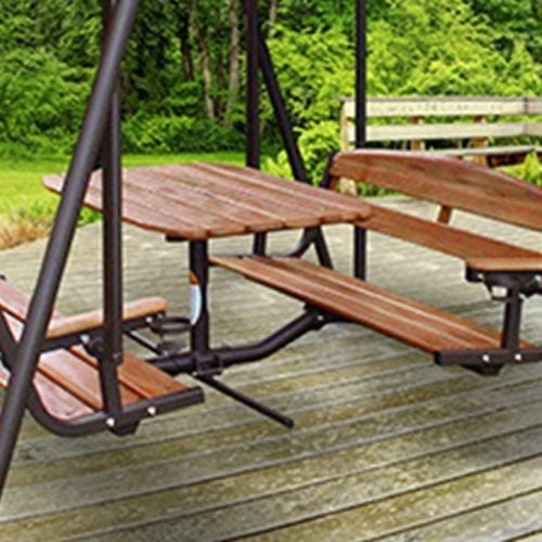 Sunset Swings 460GN original teak center table and two opposing gliding benches within a dark metal frame on a wooden deck