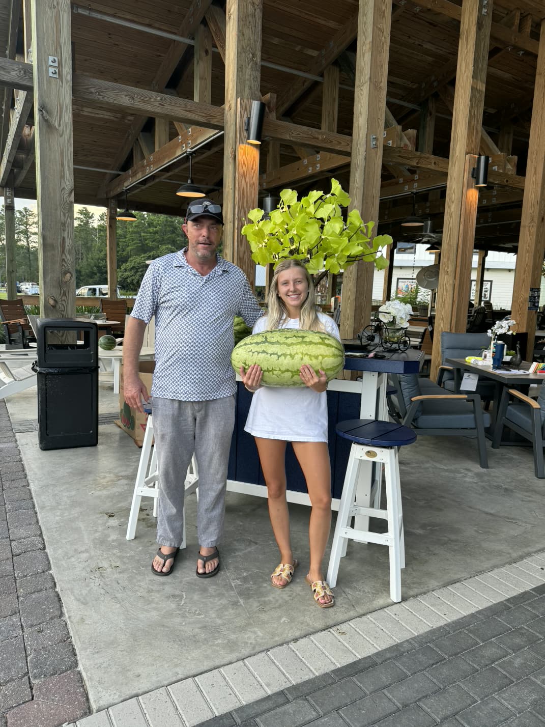 Two Props guests sharing a summer moment beneath the outdoor pavilion