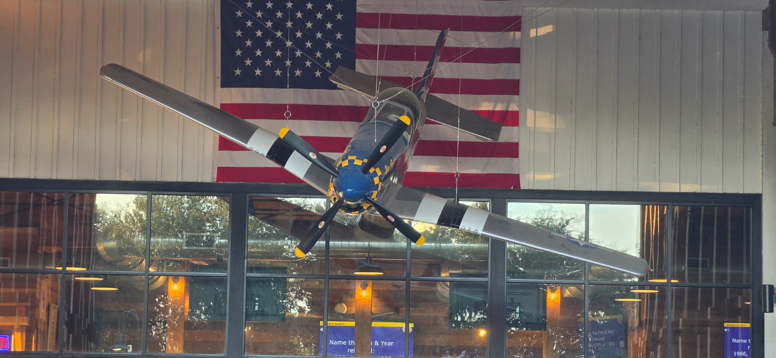 Aircraft and American flag above the bar inside Props Craft Brewery