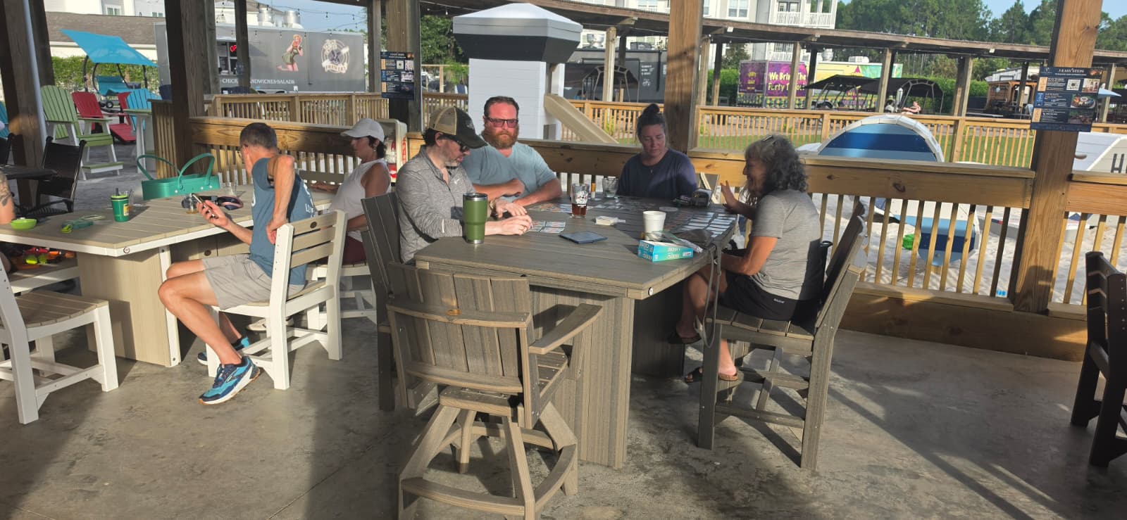 Guests gathering around Patio Vault dining furniture at Props