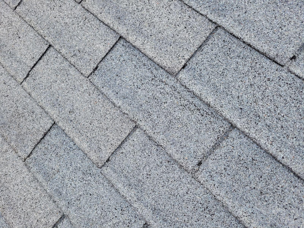 Creased shingle from wind damage on a roof in Wake Forest, NC