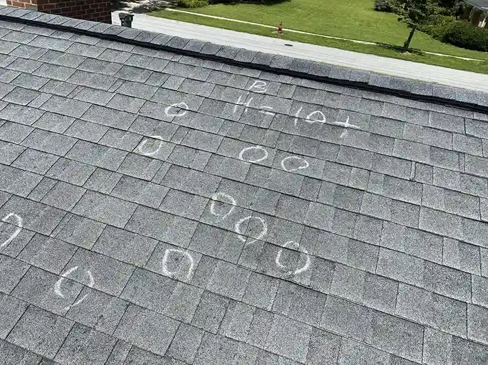 Real hail damage on a roof in Sanford NC — chalk circles marking impact points