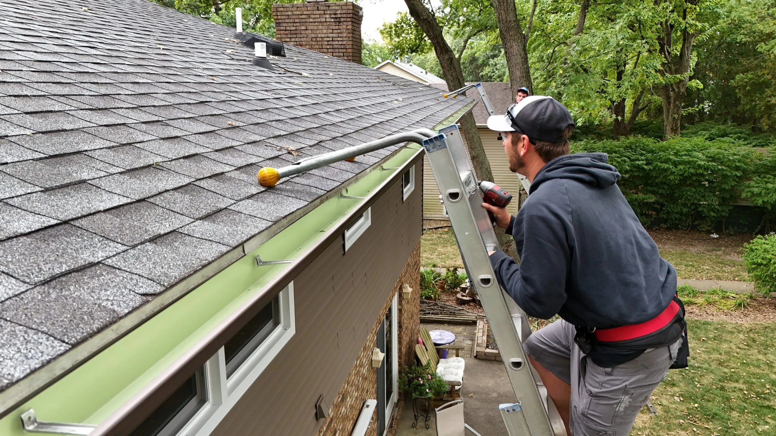 Our crew installing and securing gutters on-site