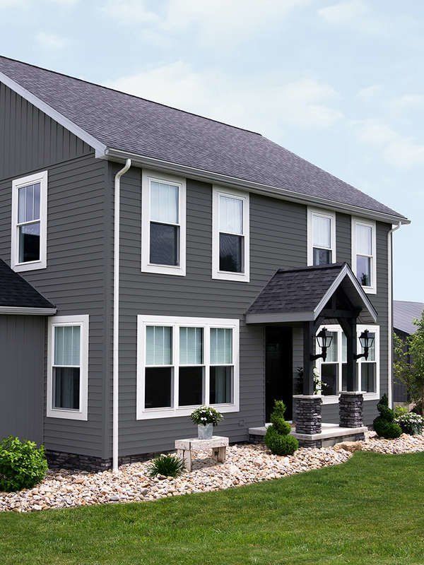 Clean white seamless gutters with matching downspout on a two-story home